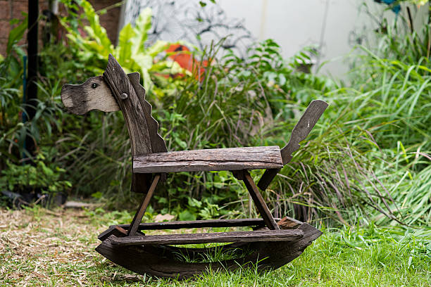 istock Wooden rocking toy on yard garden 474848160
