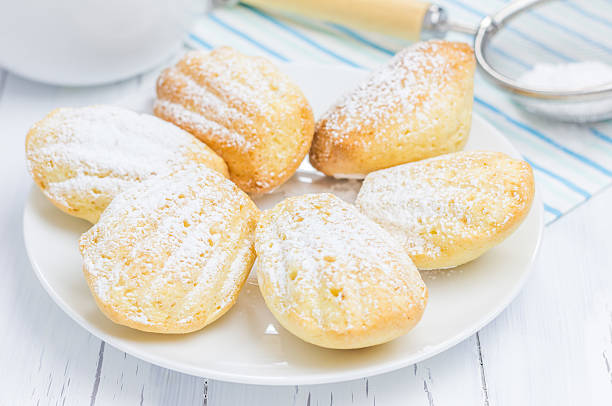 istock Sugar powdered madeleines on the white plate 474850044