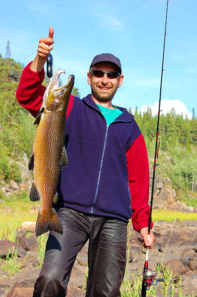 istock Fisherman weighs a beautiful male salmon. 474852570