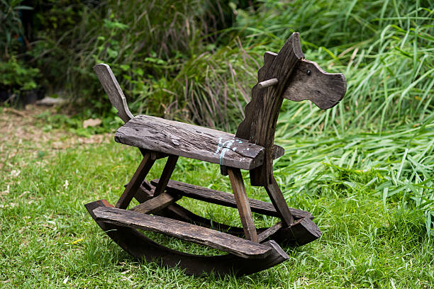 istock Wooden rocking toy on yard garden 474853046