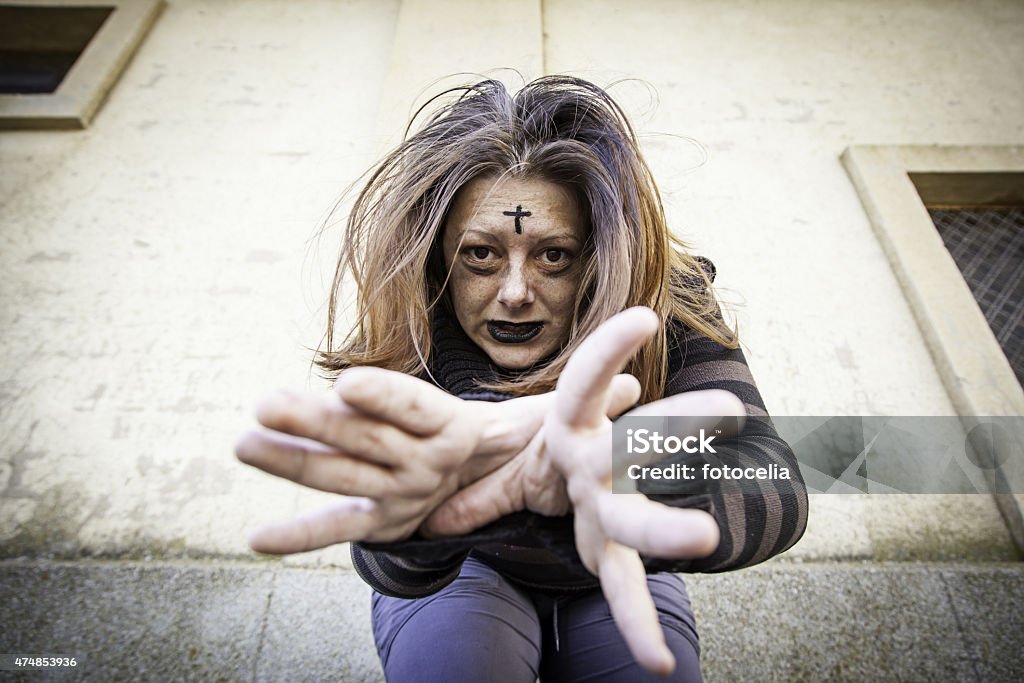 Satanic assaulting girl Girl with satanic and gothic cross, halloween 2015 Stock Photo