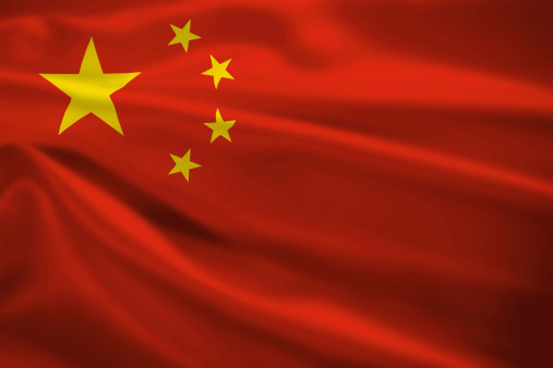 Peoples Republic of China flag blowing in the wind. Background texture.