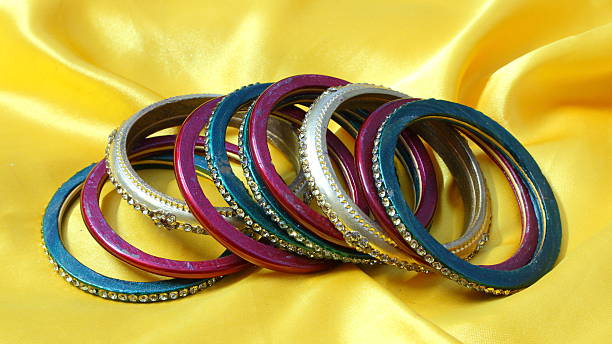 istock Bangle, Indian bracelets on yellow silky background 474857038