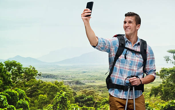 istock Smiling hiker taking a selfie at the mountain 474857562