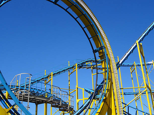 istock Image of yellow and blue rollercoaster loop, theme park / funfair 474858216