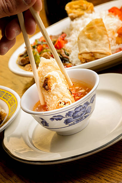 istock Fried Egg Roll being Dipped in Sweet and Sour Sauce 474858606