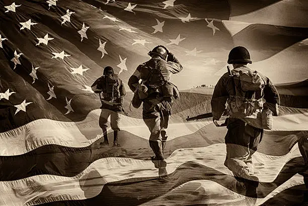 Three Active Duty American Soldiers Running Through a horizontal image of a field of stars and stripes.  Battle ready and running.  Sepia Toned.  Grain.  Composite Image.