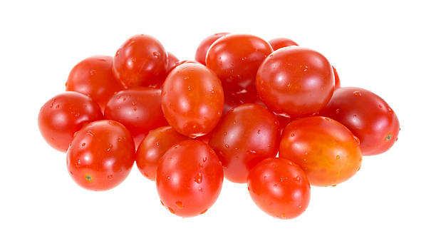 Grape tomatoes Several grape tomatoes on a white background. grape tomato stock pictures, royalty-free photos & images