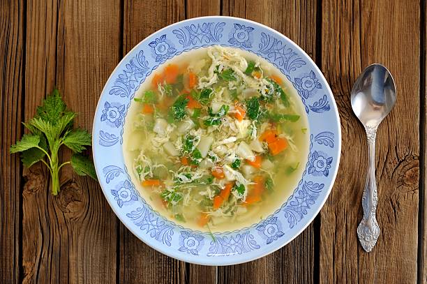istock Nettle soup with eggs in blue plate with fresh nettle 474862634