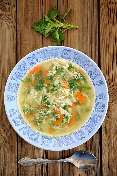 istock Nettle soup with eggs in blue plate with fresh nettle 474862956