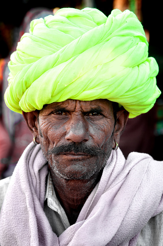 Jodhpur, India - March 3, 2013: Indian man in colourful turban posing in Jodhpur, India.