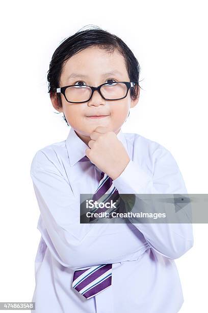 Closeup Business Kid Thinking Isolated Stock Photo - Download Image Now - 2015, Asian and Indian Ethnicities, Aspirations