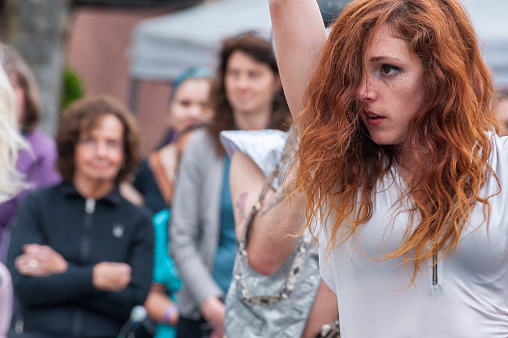 McMinnville, Oregon, USA - May 16, 2015: Portland's Marching Band, LoveBoob Go-Go, puts on a show at the Annual UFO Fest as one of the dancers with red hair performs for the crowd.