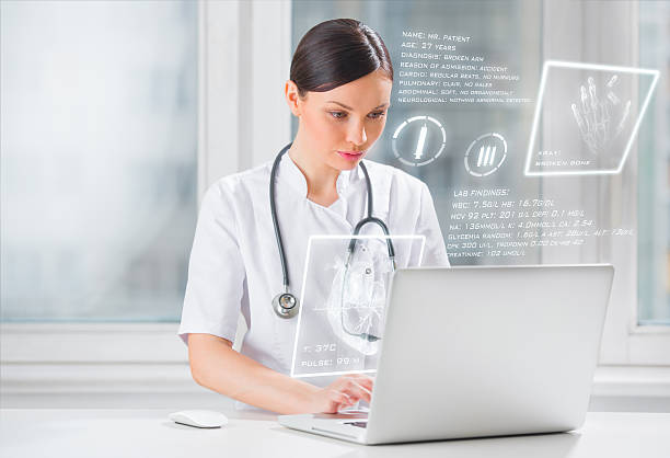 Pretty female medicine doctor working with modern computer interface stock photo