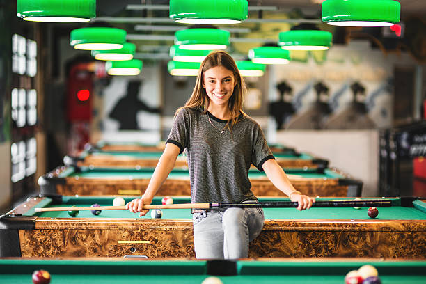 istock Happiness girl standing in a pub at the pool table 474867674