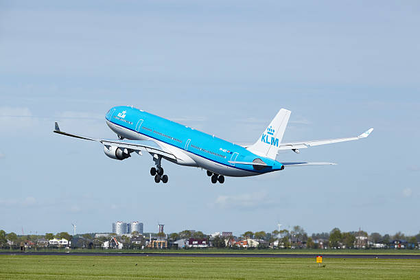 Amsterdam Airport Schiphol - Airbus A330 of KLM takes off Amsterdam, The Netherlands - May 13, 2015: An Airbus A330-303 of KLM takes off at Amsterdam Airport Schiphol (The Netherlands, AMS) on May 13, 2015. The name of the runway is Polderbaan. klm stock pictures, royalty-free photos & images