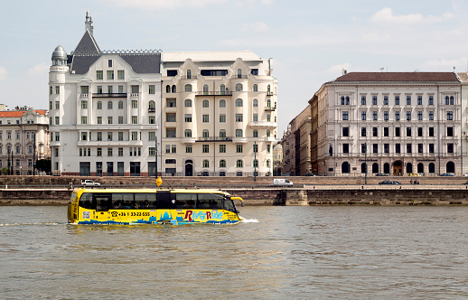 Budapest, Hungary - April 30, 2015: Sightseeing amphibian bus is swimming in the Danube with tourists.