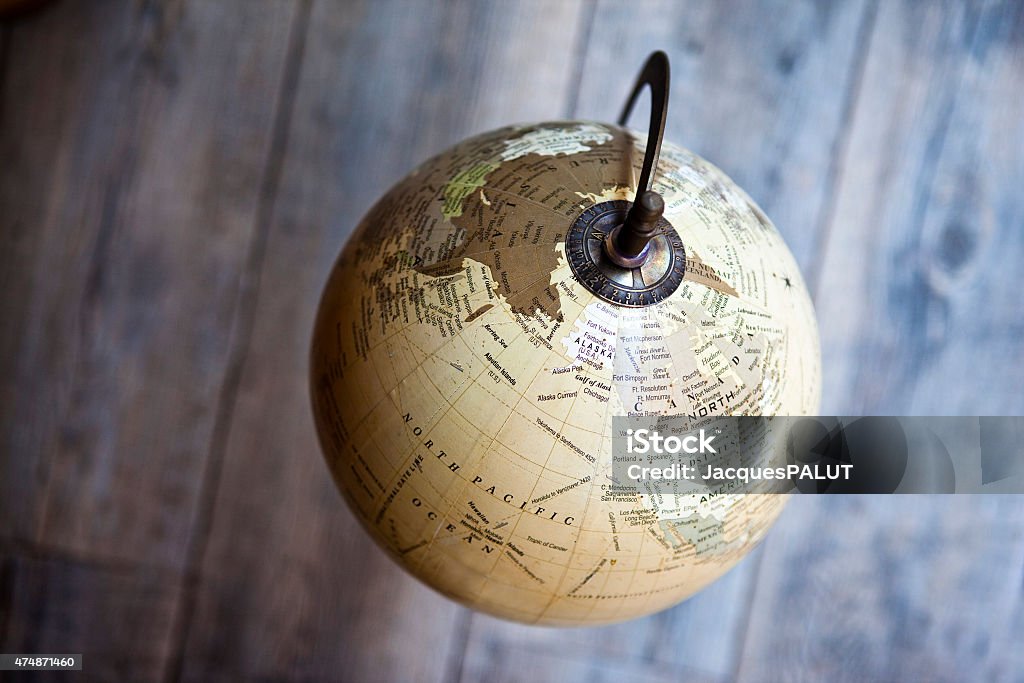 Globe Old terrestrial globe on a wooden floor Globe - Navigational Equipment Stock Photo