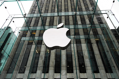 New York, USA  - October 3, 2010: the Apple Store with big logo under bad weather in Fifth Avenue in New York. the store is designed as the exterior glass box above the underground display room