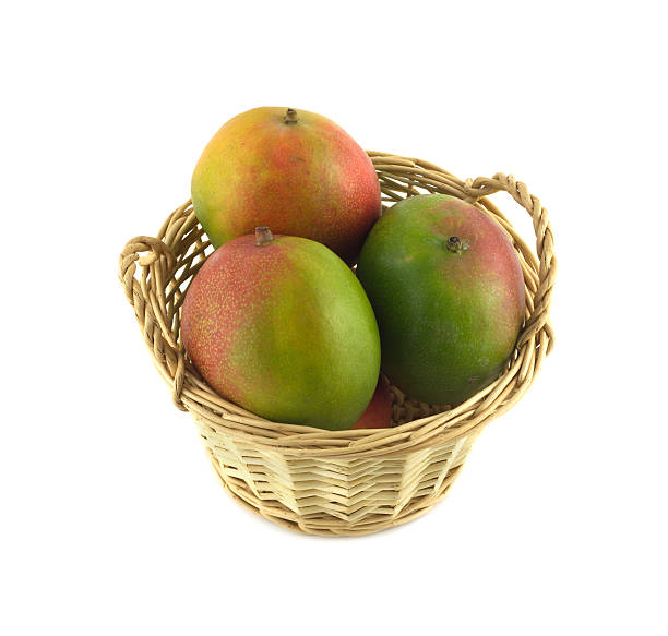 istock Ripe mango in a wicker basket isolated close up 474876541