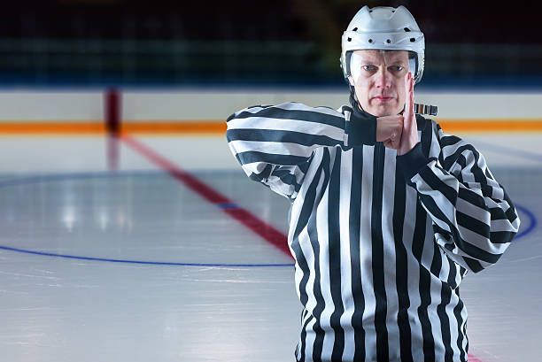 istock Hockey referee demonstrate a penalty 474878051