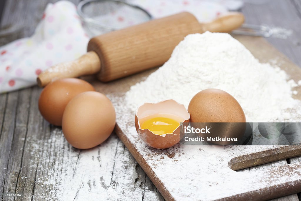 Ingredients for baking Baking ingredients - flour, eggs and rolling pin on a table Backgrounds Stock Photo