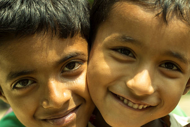 istock Two Indian village boys smile at camera closeup 474880694