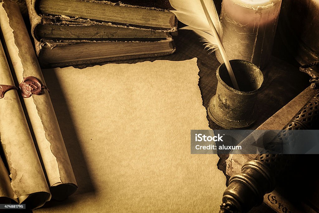 Blank parchment Blank parchment surrounded by books,scrolls and feather pen Paper Scroll Stock Photo