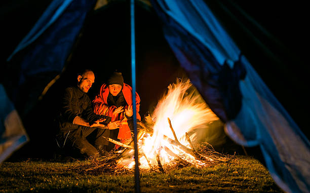 istock Couple near camp fire warming up 474883878