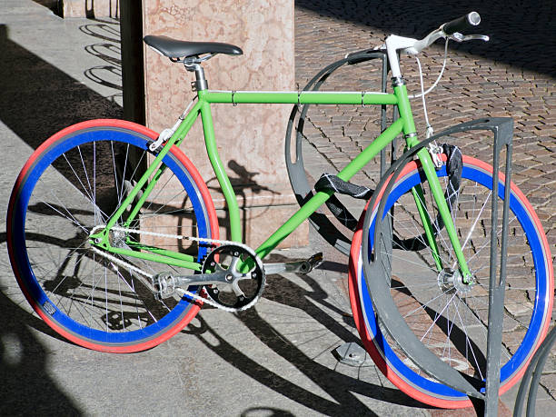 istock locked colored bike  parked on the sidewalk 474884767