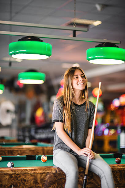 istock Happiness girl standing in a pub at the pool table 474886592