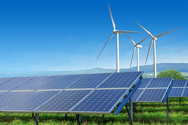 istock solar panels and wind turbines under blue sky 474887308