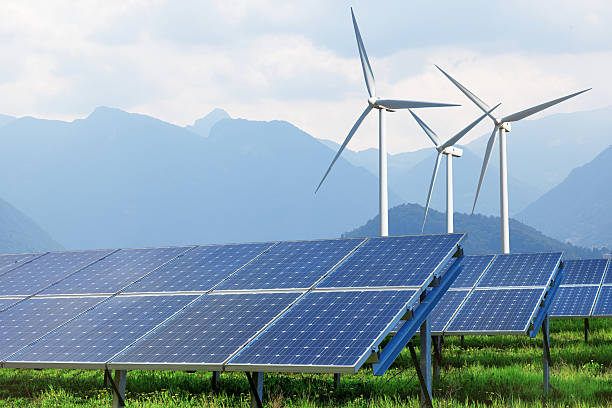 istock solar panels and wind turbines against mountains 474887554