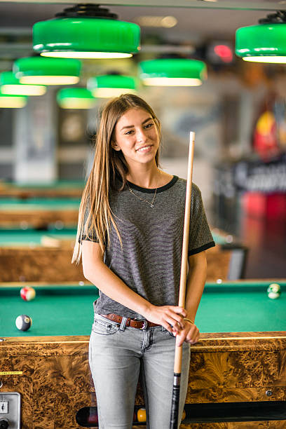 istock Happiness girl standing in a pub at the pool table 474888690