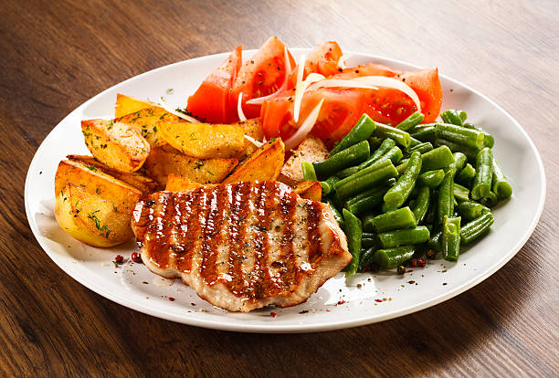 istock Grilled steak, baked potatoes and vegetables 474894553