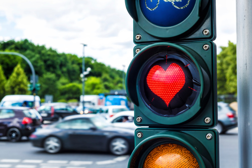 Traffic light with heart shaped red lamp