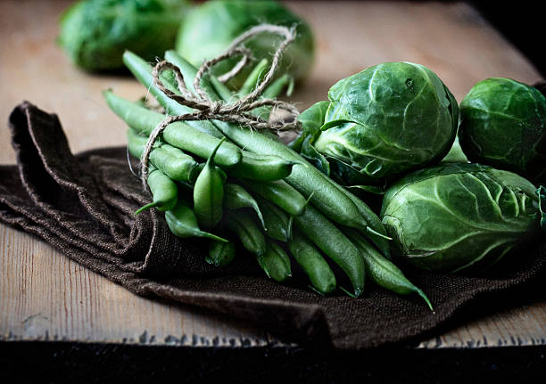 Close up of green beans and brussels sprouts.