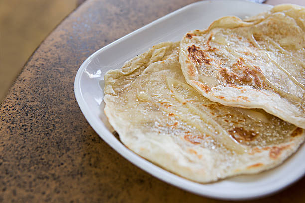 istock roti with sweetened condensed milk and sugar on top 474898960