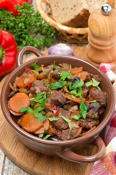 istock Stew with beef, prunes, vegetables and parsley, top view 474900311
