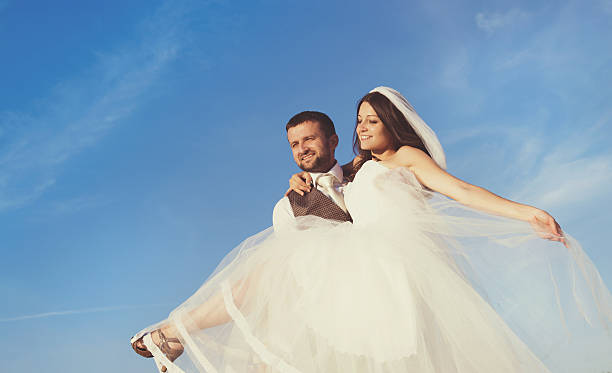 istock Newly married couple portrait with blue sky 474903403