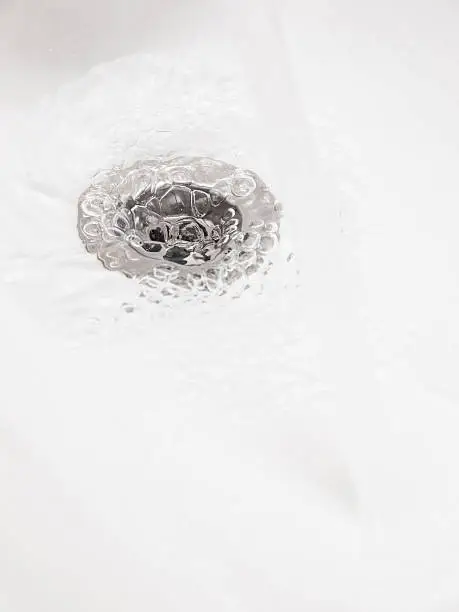 Plughole with water in vertical composition