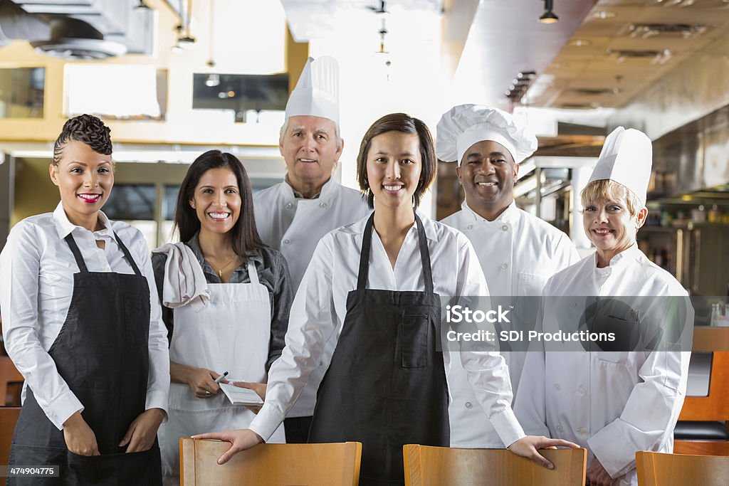 Diverse staff of chefs and waiters in modern restaurant kitchen Chef Stock Photo