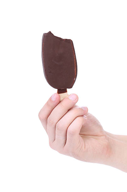 istock Hand holds bitten chocolate vanilla ice cream. 474909341