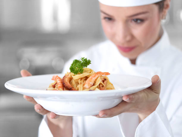 istock Young Female Chef Looking At The Delicious Shrimp Pasta 474912422