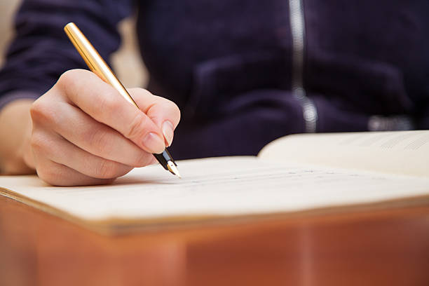 istock Hand with pen and music sheet 474914745