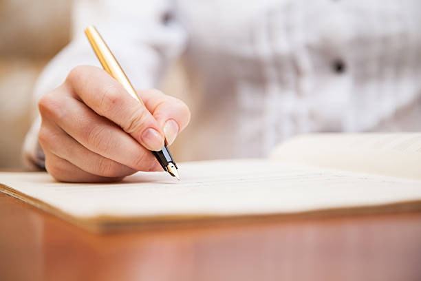istock Hand with pen and music sheet 474914771