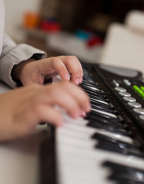 istock Little boy playing electronic piano 474921620