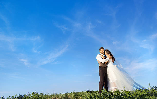 istock Newly married couple portrait with blue sky 474922855