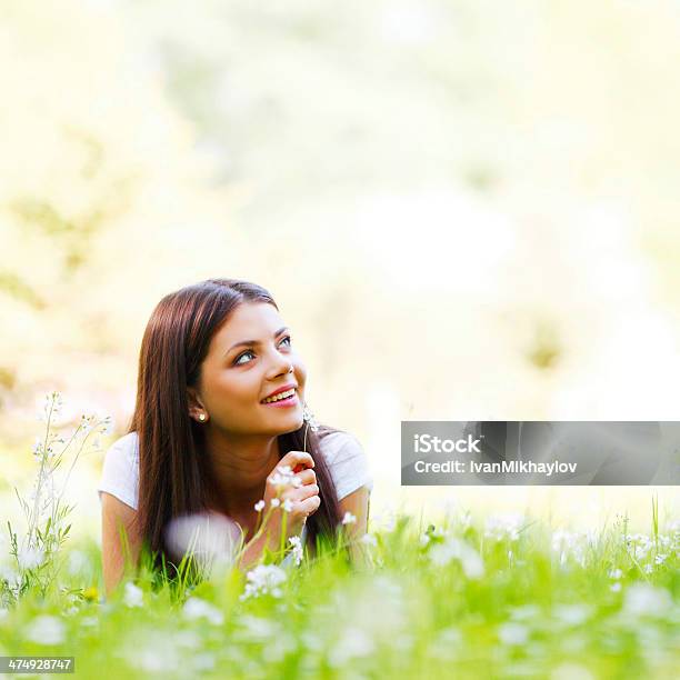 Woman Laying In Sunny Spring Park Stock Photo - Download Image Now - Adult, Adults Only, Beautiful People