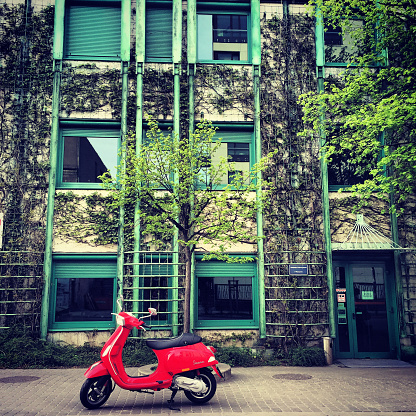 Warsaw, Poland  - April 27, 2015: Red Vespa parked near University Library in Warsaw, Poland
